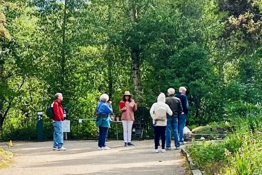 Group of men and women walking on dirt pathway during a tour.