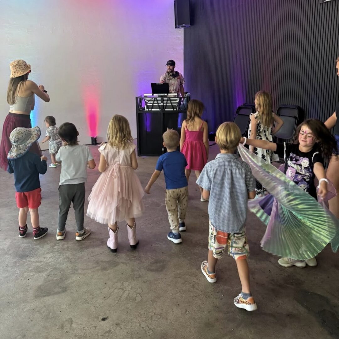 Children dancing in front of dj
