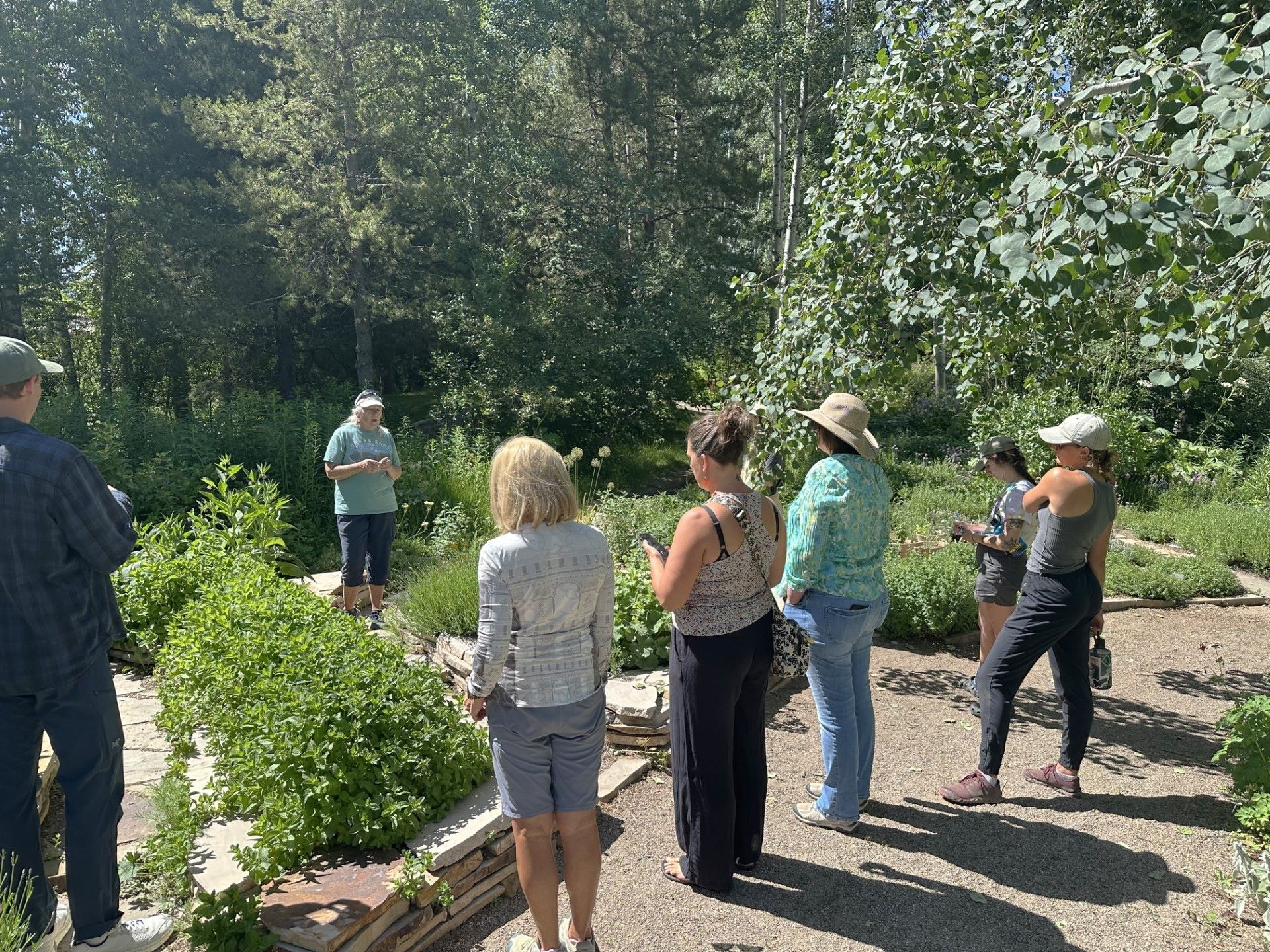 Gardener leading a talk for an audience in a garden