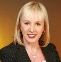 Professional headshot of a blog woman in a blank blazer smiling