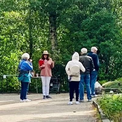 Group of men and women walking on dirt pathway during a tour.